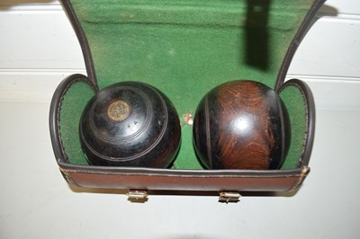 Lot 110 - Case of two hardwood lawn bowls