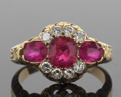 Lot 450 - Ruby and diamond triple cluster ring featuring...