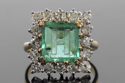 Lot 34 - An emerald and diamond ring, the emerald...