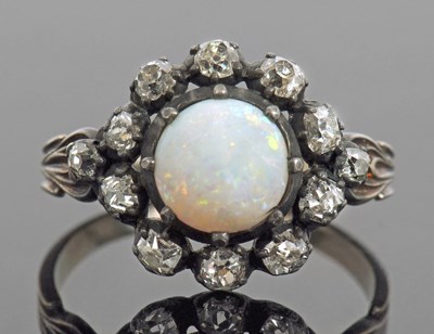 Lot 473 - Opal and diamond cluster ring, the round cut...