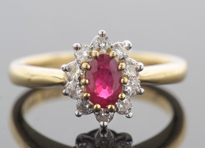 Lot 33 - 18ct gold ruby and diamond cluster ring, the...