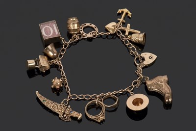 Lot 490 - 9ct gold curb link bracelet suspending various...