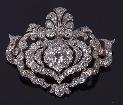 Lot 512 - Diamond brooch/pendant, a floral an scrolled...
