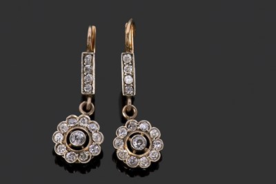 Lot 514 - A pair of diamond drop earrings comprising a...