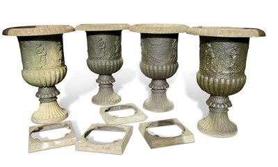 Lot 574 - Set of four continental cast iron garden urns...