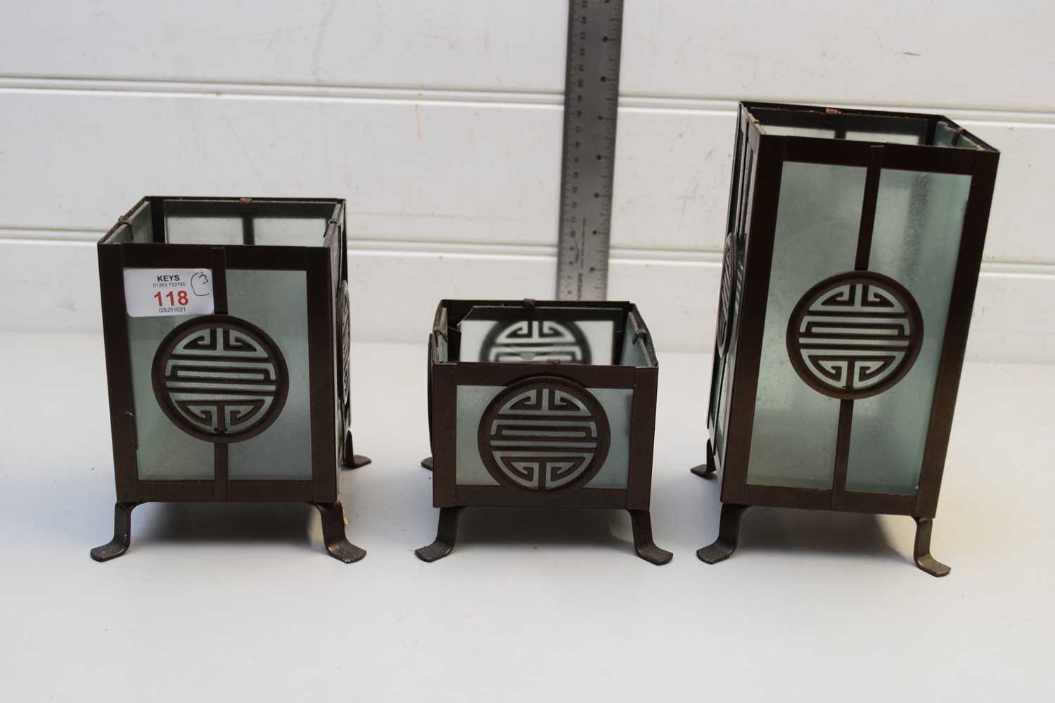 Lot 118 - FOUR MODERN METAL FRAMED CHINESE CANDLE HOLDERS
