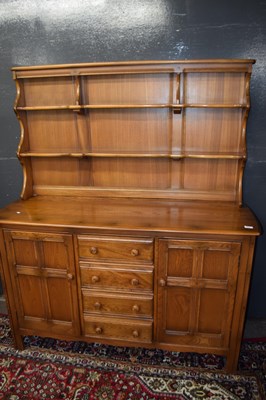 Lot 562 - Ercol elm dresser with shelved back over a...