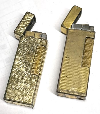 Lot 102 - Two gold plated Dunhill gas lighters, each...