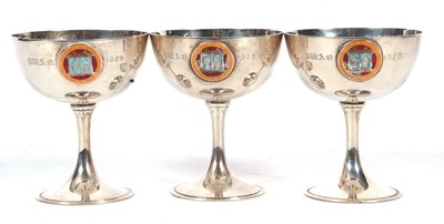 Lot 232 - Three George V silver goblets, each applied...