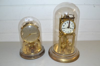 Lot 62 - Two brass anniversary clocks under glass domes