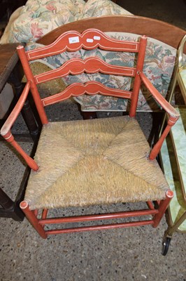 Lot 311 - A rush seated ladder back armchair with red...