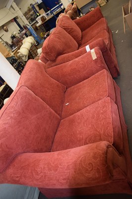 Lot 814 - Modern red upholstered three seater sofa and...