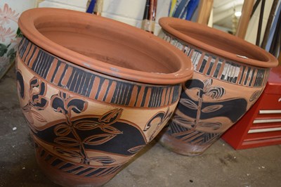 Lot 882 - Pair of terracotta plant pots with floral design