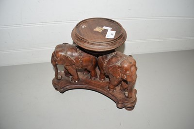 Lot 36 - Hardwood stand decorated with elephants