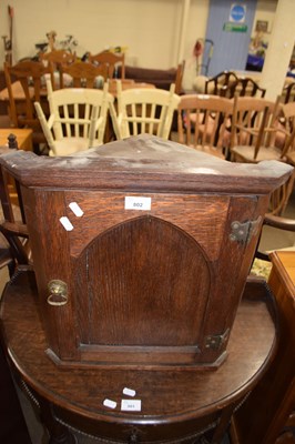 Lot 802 - Small oak corner cabinet with arched panel door