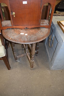 Lot 825 - Small oak circular topped table with carved...