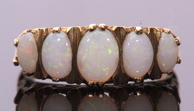 Lot 6 - 9ct gold five stone opal ring featuring oval...