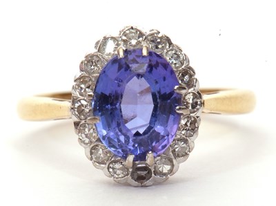 Lot 13 - Tanzanite and diamond cluster ring, the oval...