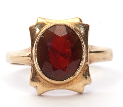 Lot 24 - 9ct gold garnet set ring, the oval faceted...