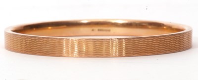 Lot 90 - 9ct gold bangle with overall engraved with a...