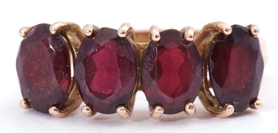 Lot 46 - Garnet four stone ring, a row of uniform oval...