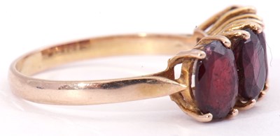 Lot 46 - Garnet four stone ring, a row of uniform oval...
