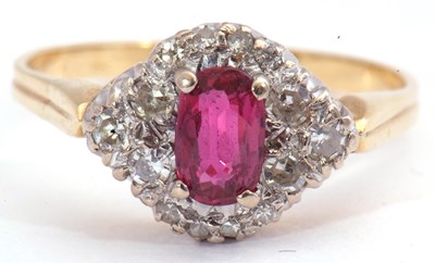 Lot 80 - Ruby and diamond ring centring an oval cut...