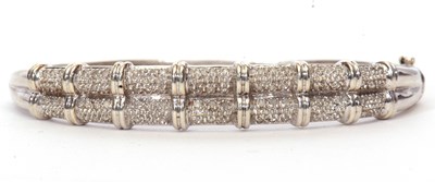 Lot 149 - Modern 9ct white gold and diamond hinge...