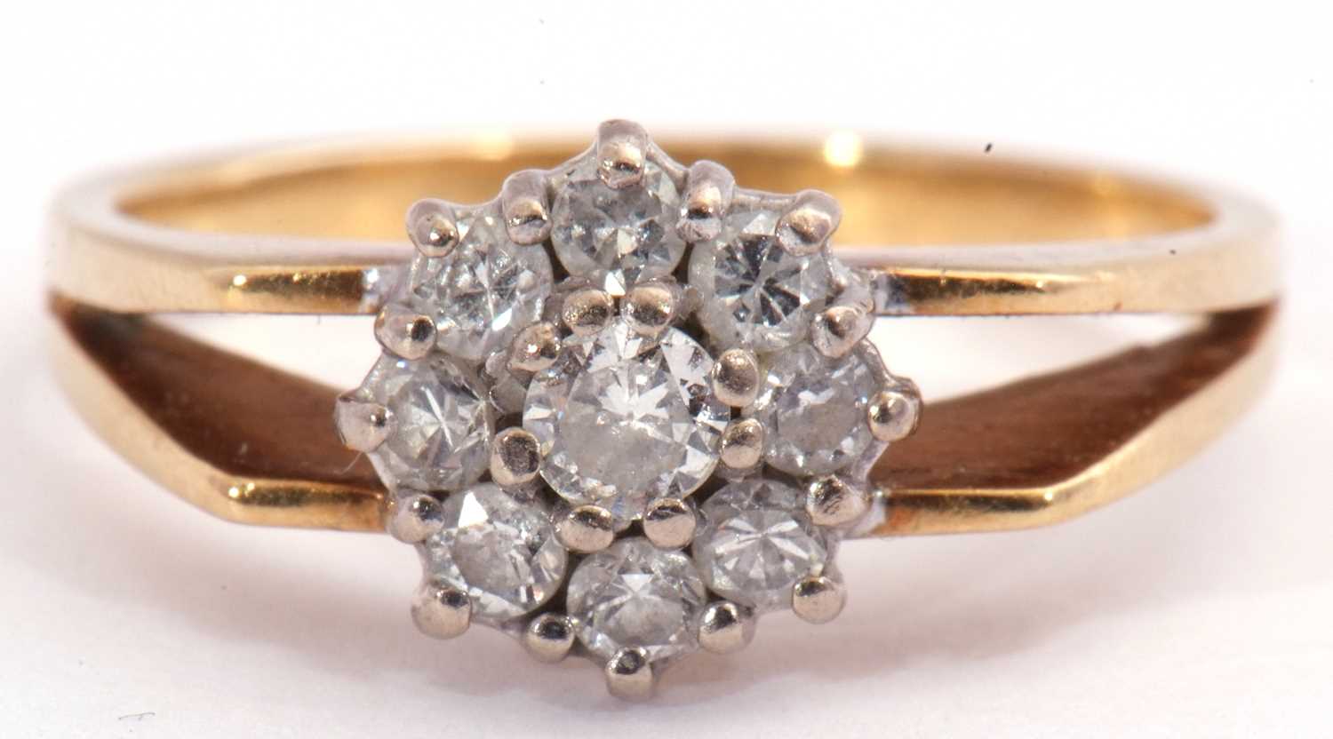 Lot 82 - Diamond cluster ring, a flowerhead design,...