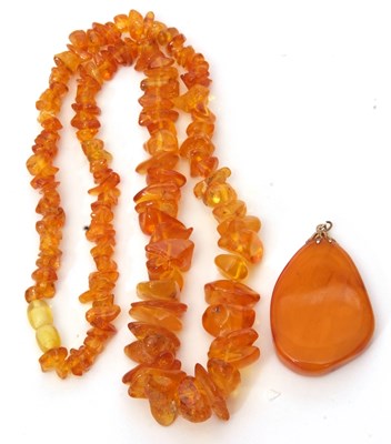 Lot 198 - Modern amber pendant and a amber fragment...