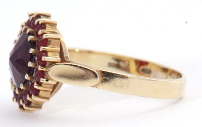 Lot 101 - Garnet cluster ring, the large round cut...
