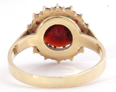 Lot 101 - Garnet cluster ring, the large round cut...