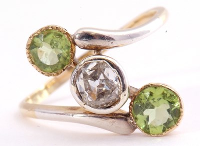 Lot 109 - Diamond and peridot cross over ring centring...