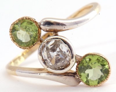 Lot 109 - Diamond and peridot cross over ring centring...
