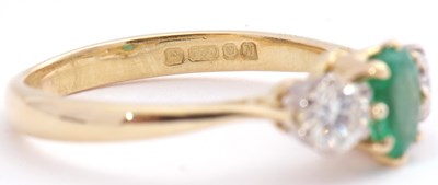 Lot 110 - 18ct gold emerald and diamond three stone ring,...