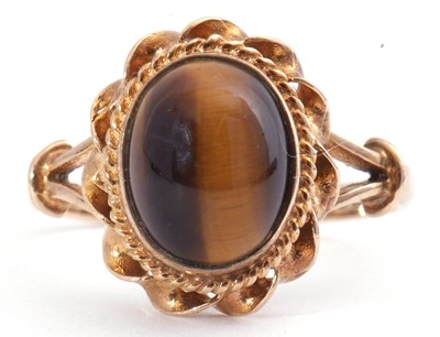 Lot 116 - 9ct gold tigers eye ring, the cabochon stone...