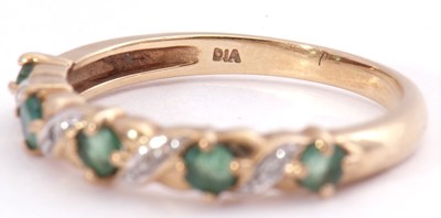 Lot 124 - Modern diamond and emerald half eternity ring,...