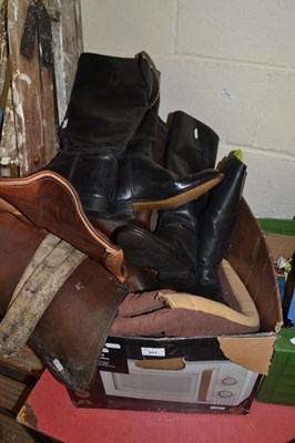Lot 917 - Two pairs of riding boots and a saddle