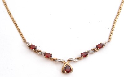 Lot 254 - Garnet and diamond pendant/necklace set with...