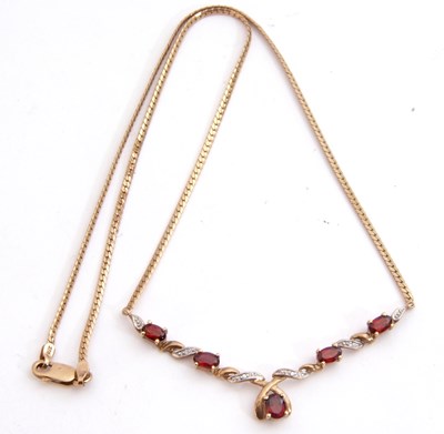 Lot 254 - Garnet and diamond pendant/necklace set with...