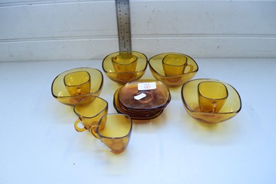 Lot 187 - AMBER GLASS COFFEE CUPS AND SAUCERS AND...