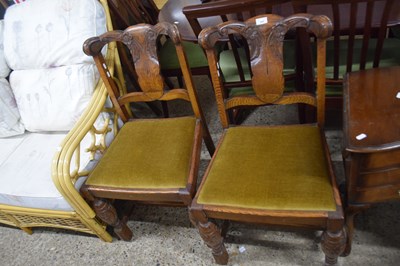 Lot 304 - Pair of oak dining chairs with carved floral...