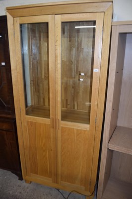 Lot 325 - Modern light oak glazed display cabinet with...