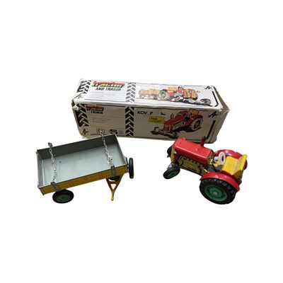 Lot 173 - A clockwork tinplate Zetor tractor and hay...