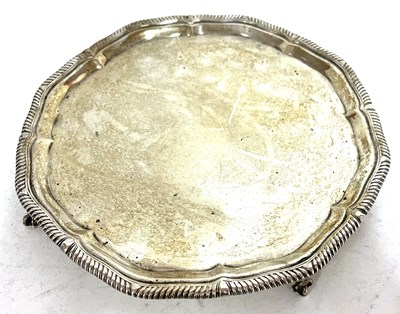 Lot 128 - George V silver salver, the scalloped rim with...