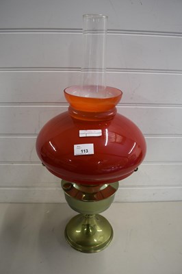 Lot 113 - 20TH CENTURY OIL LAMP WITH RED GLASS SHADE