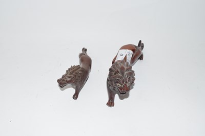 Lot 97 - Two Oriental carved hardwood model lions