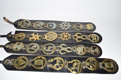 Lot 184 - Four leather straps containing various...