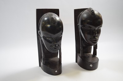 Lot 255 - Two wooden African carved heads modelled as...