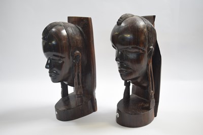 Lot 255 - Two wooden African carved heads modelled as...